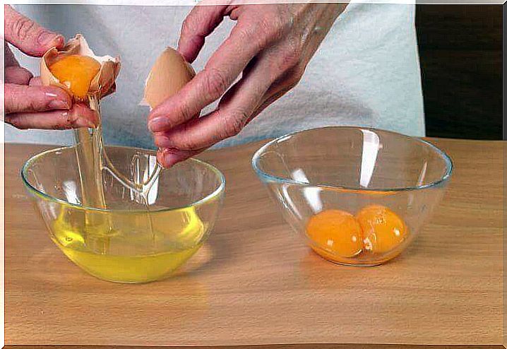 Woman separating yolks from egg whites