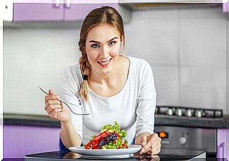 Woman eating salad.