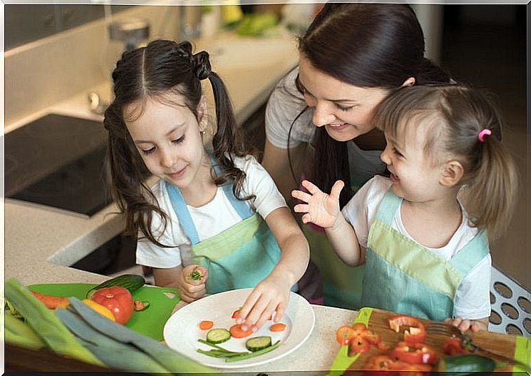 Mom cooks with her daughters