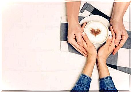 Hands with heart cappuccino.