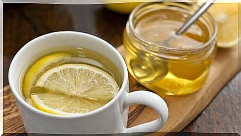 Cup with lemon and honey herbal tea