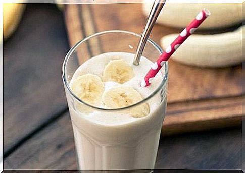 Glass with banana smoothie and straw