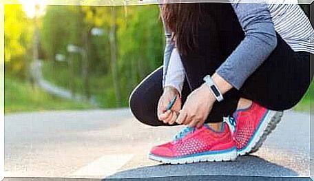 Girl tying her shoes.