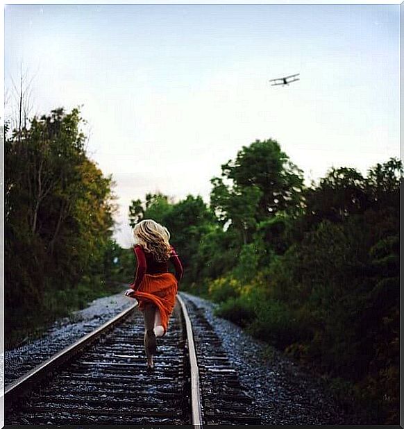 Woman running on the rails