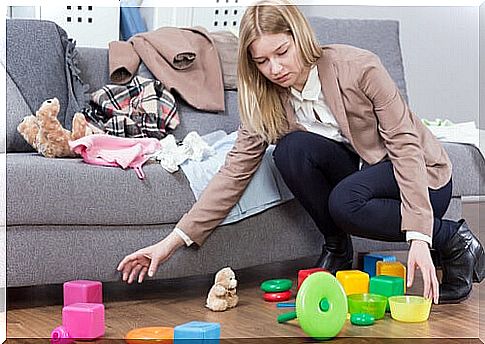 Woman tidies up toys