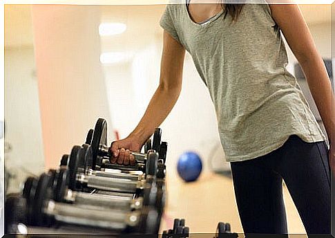 Woman taking weights