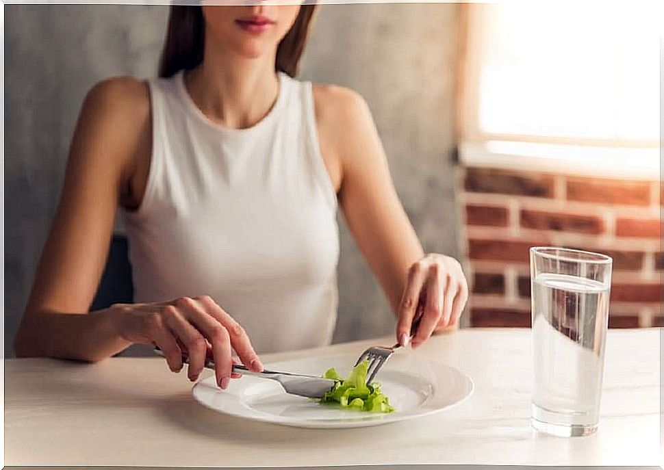 Skinny girl in front of poor plate