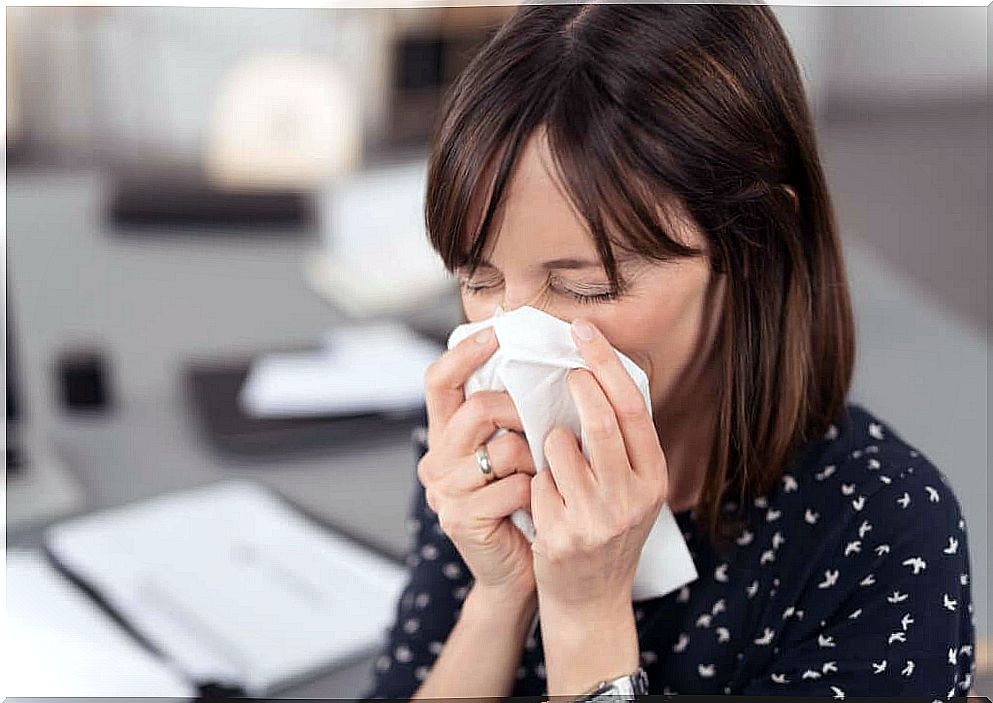 Woman blowing her nose 