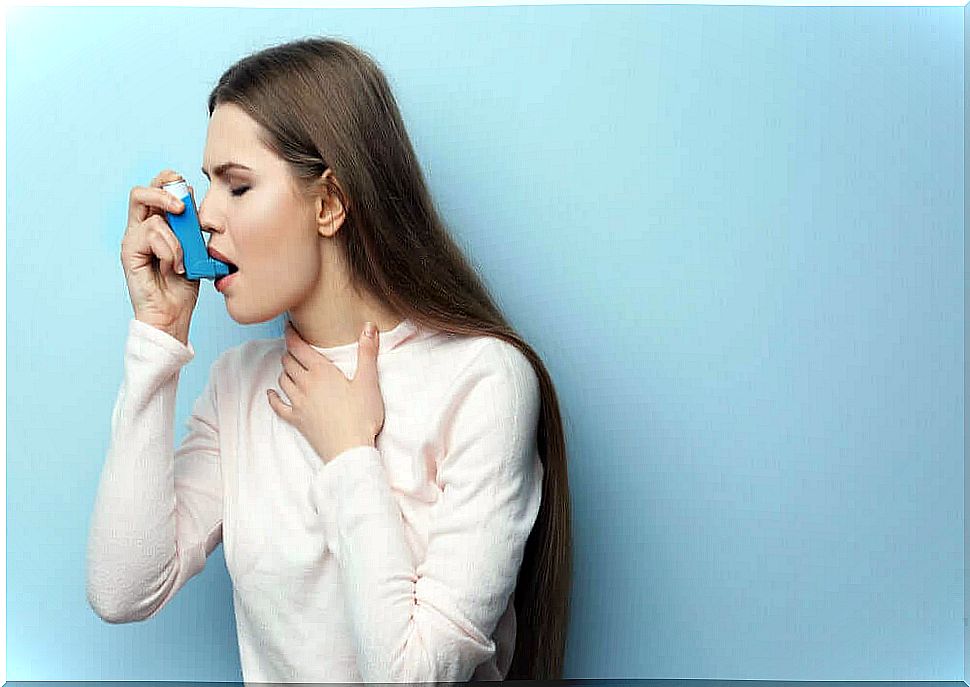 Woman using asthma inhaler.