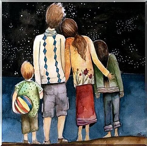 Shoulders family looking at the starry sky