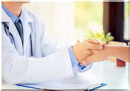 Doctor holding a patient's hand.