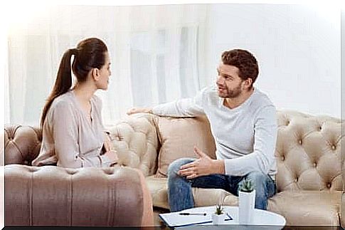 Couple talking in a hall.